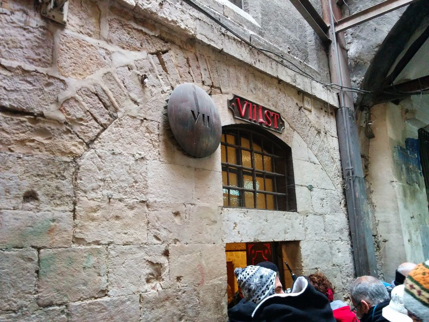 A Via Dolorosa station marker on Old City stone